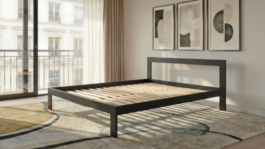 Modern bedroom with a black metal bed frame, abstract art on the wall, and large windows.